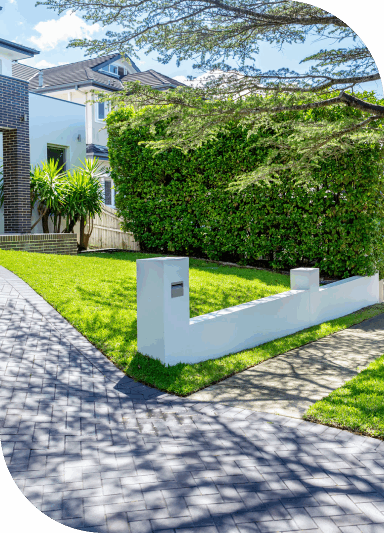 Modern house with lush green hedges outside.