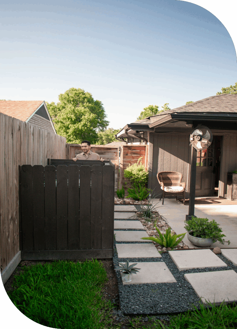 Backyard with pathway and wooden fence.